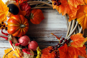 Decorative wreath, autumn theme with leaves and pumpkins, in honor of Halloween.