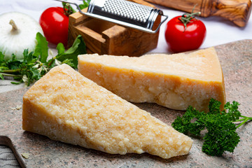 Italian original aged Parmesan cheese in two pieces close up