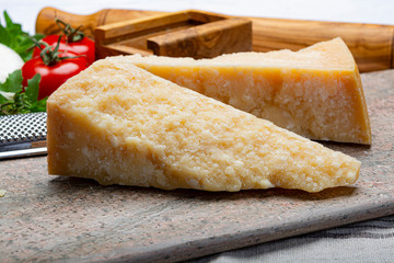 Italian original aged Parmesan cheese in two pieces close up