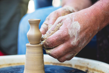 Potter at work. Making a pitcher of clay on a pottery wheel_