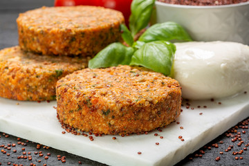 Tasty vegetarian burgers made from healthy quinoa, basil, tomatoes and mozzarella cheese