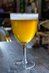 Famous Belgian beer served outside in small old cafe in special Belgian beer glass