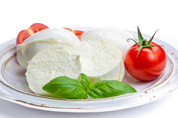 Italian soft cheese mozzarella, white cheese made from cow or buffalo milk with fresh green basil herb and red tomato