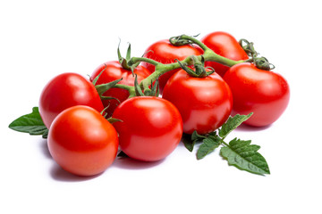 Bunch of fresh ripe red tomatoes with leaves isolated on white background