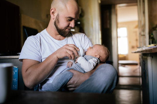 Father feeding newborn