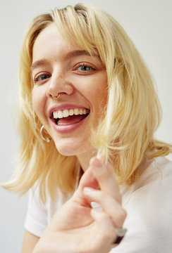 Dynamic portrait of a smiling young blonde woman.