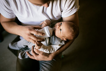 Overhead view of father feeding baby
