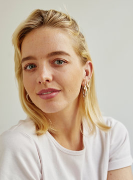 Portrait of a young blonde woman in a white t-shirt.