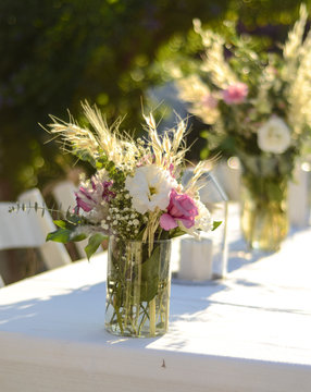 Luxury floral arrangement of pink and white flowers in glass vases. Flowers for wedding decoration