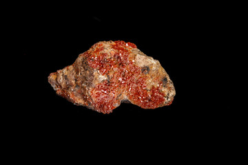 Macro mineral stone Vanadinite on a black background