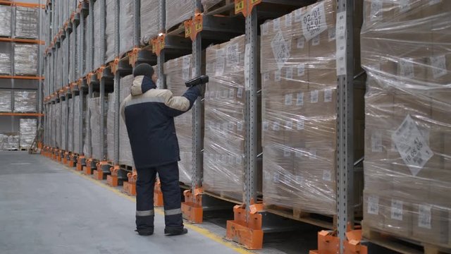 Follow footage of employees male warehouse worker engineer in hard hat working. walking through logistics center warehouse factory construction site logistics architect businessman man builder indoors