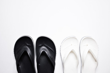 Flip Flops on a white isolated background. Black male and female white.