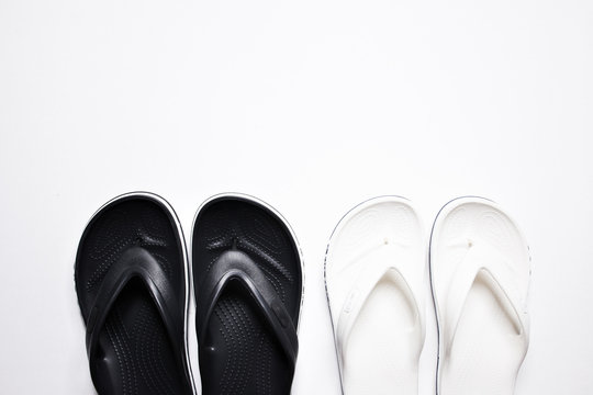 Flip Flops on a white isolated background. Black male and female white.