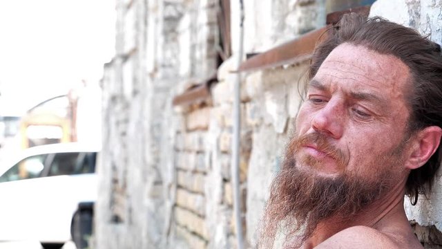 Down-and-out person on the street. Real person with no fixed abode, homeless man