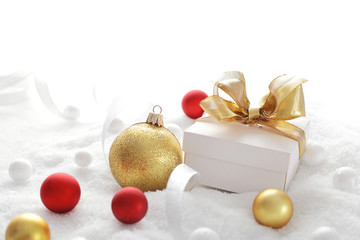 Fototapeta na wymiar Christmas gift boxes and ornaments on the snow