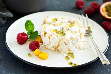 Meringue roulade with raspberries and passion fruit. Pavlova. Dessert. Selective focus