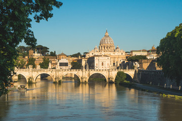 Naklejka premium Vatican dome of Saint Peter Basilica (Italian: San Pietro) and Sant'Angelo Bridge, over Tiber river, Rome