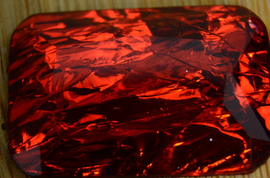 Red diamond stone texture on wooden background