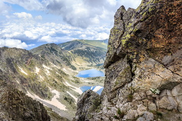 Dramatic clouds over Rila lakes and amazing, rocky valley view from hiking track to Musala summit