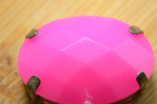 Isolated pink diamond stone on wooden background