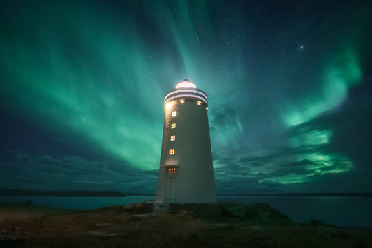 Amazing beacon with bright light located against wonderful starry sky in beautiful winter countryside