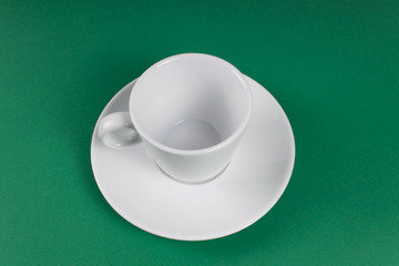 White cup on a white saucer on a plain background