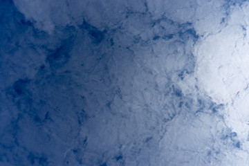 The texture of the clouds. Abstract white, on a blue background.