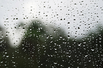 Close-up of a raindrop on a window after a tropical rain.