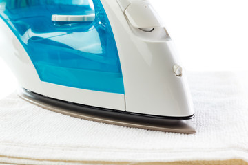 The electric iron stands on isolated white background