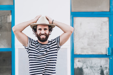 Young male in hat and striped t-shirt