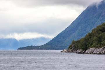 Obraz premium clouds over the fjord and mountains in Norway