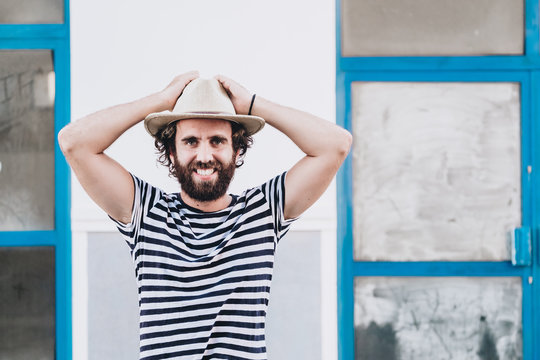Young male in hat and striped t-shirt