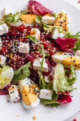 Fresh mixed salad in a bowl on a white background