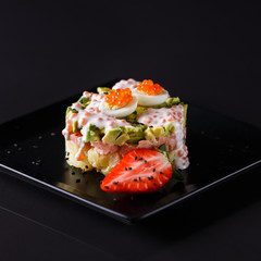 Round salad made of red fish potato and avocado