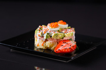 Round salad made of red fish potato and avocado