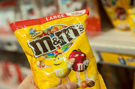 Mulhouse - France - 8 February 2018 - closeup of chocolate-coated peanuts from M & m's brand in hand at Super U supermarket