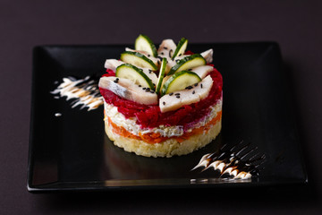 Russian salad herring under fur coat on a dark background