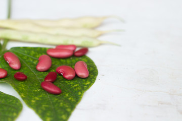Red kidney beans on white wooden background. Flat lay