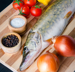Uncooked fish on cutting board in meal preparation concept