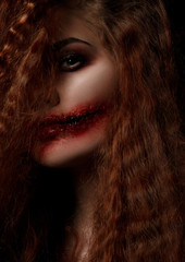 Red hair woman looking to the camera with one eye, Horror concept