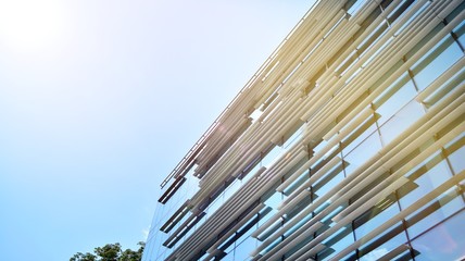 Obraz premium Modern office building detail, glass surface with sunlight