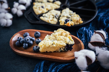 close up of one blueberry scone, dark background