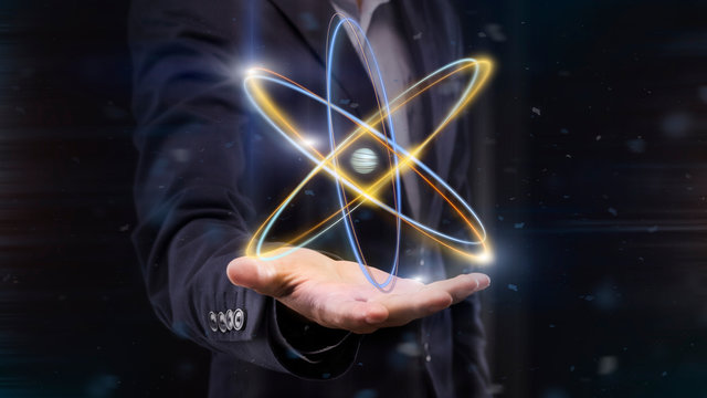 Hologram of atom on male hand, panorama