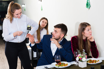 Man is talking with woman stranger in time dinner with girlfriend