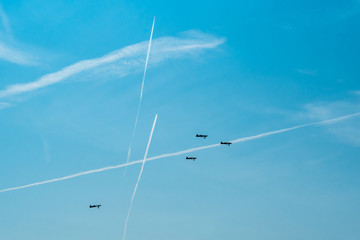 Traces of airplanes in the sky. Elements of aerobatics on a sports plane.