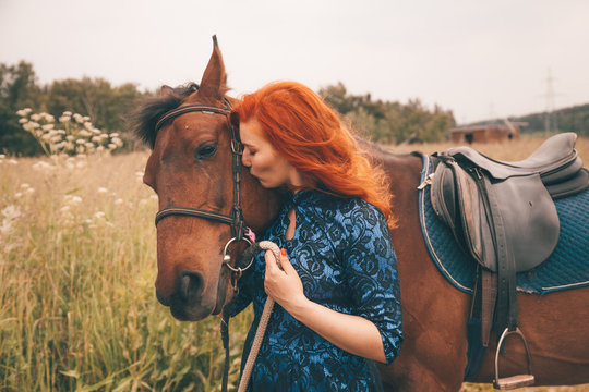 Beautiful girl with her horse walking together