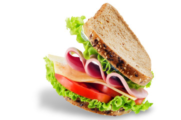 Sandwich with whole grain bread, salad, cheese, tomato and ham on a white isolated background