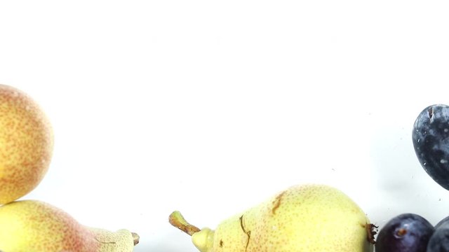 Organic and fresh pears and plums fall into water