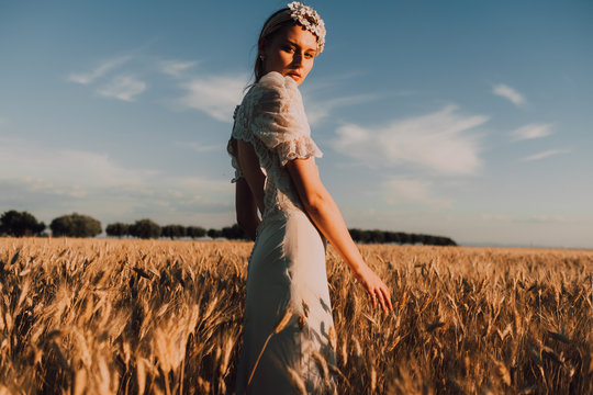 Woman in middle of wheat field