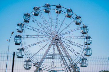 Ferris wheel against the background of the summer sky